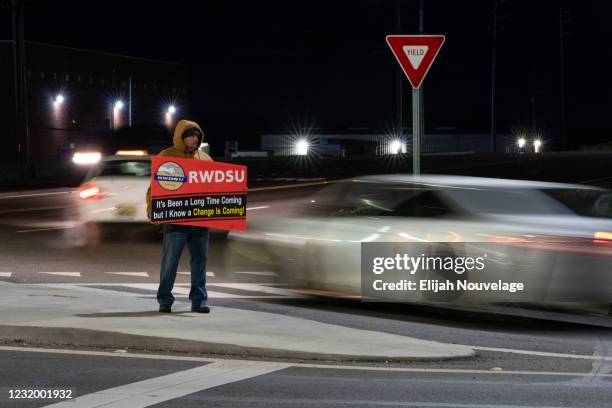 An RWDSU union rep holds a sign outside the Amazon fulfillment warehouse at the center of a unionization drive on March 29, 2021 in Bessemer,...