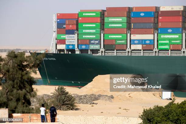 People watch as the container ship 'Ever Given' is refloated, unblocking the Suez Canal on March 29, 2021 in Suez, Egypt. This morning the container...