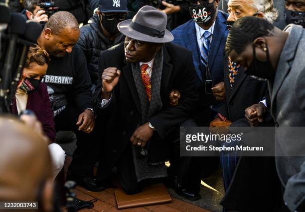 Attorney Ben Crump takes a knee with members of George Floyd's family and Rev. Al Sharpton for 8 minutes and 46 seconds outside the Hennepin County...