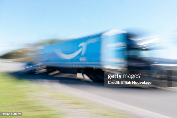 Truck with the Amazon Prime logo on it passes by the Amazon fulfillment warehouse at the center of a unionization drive on March 29, 2021 in...