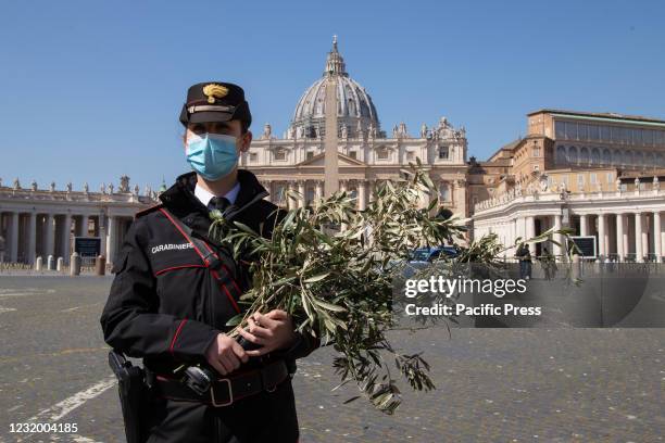 Police woman with an olive branch on Palm Sunday in St. Peter's Square in Rome.