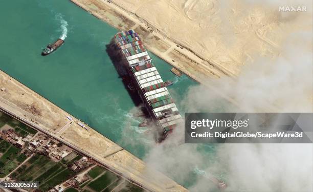 Maxar new high-resolution satellite imagery of the Suez canal and the container ship that remains stuck in the canal north of the city of Suez,...