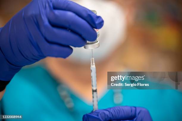 Nurse fills up a syringe with the Moderna COVID-19 vaccine at a vaccination site at a senior center on March 29, 2021 in San Antonio, Texas. Texas...