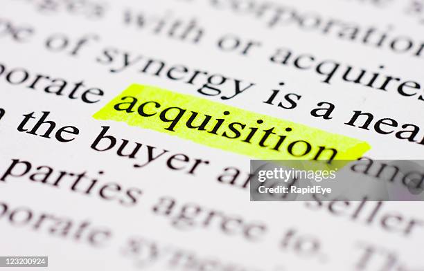 acquisition highlighted in yellow on printed page. - fusies en overnames stockfoto's en -beelden