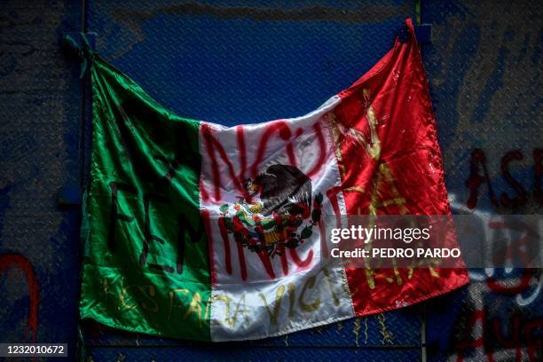 View of a Mexican flag reading Cancun guilty of femicide. We are missing Victoria during a protest in Mexico City on March 29 for the death of...