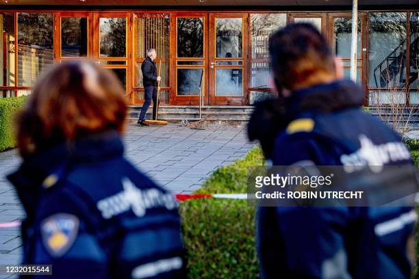 Church workers clean up the damages outside the Mieraskerk , following a small explosion, on March 30, 2021. - Dutch police said a small explosion on...
