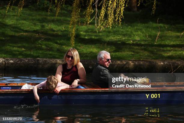 People punt on the River Cam on March 30, 2021 in Cambridge, England. Forecasters are predicting temperatures of 22C and with the easing of pandemic...