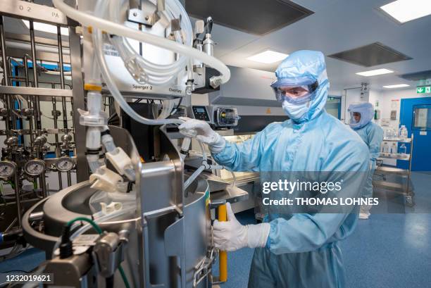 Employees in cleanroom suits test the procedures for the manufacturing of the messenger RNA for the Covid-19 vaccine at the new manufacturing site of...