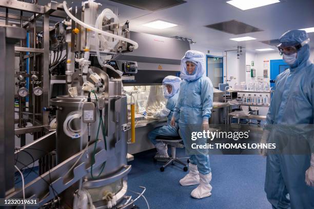 Employees in cleanroom suits test the procedures for the manufacturing of the messenger RNA for the Covid-19 vaccine at the new manufacturing site of...