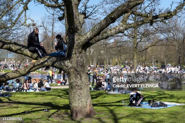 Members of the public gather on a sunny day in the Vondelpark in Amsterdam on March 30 amid the Covid-19 pandemic. - Access to the park has been...