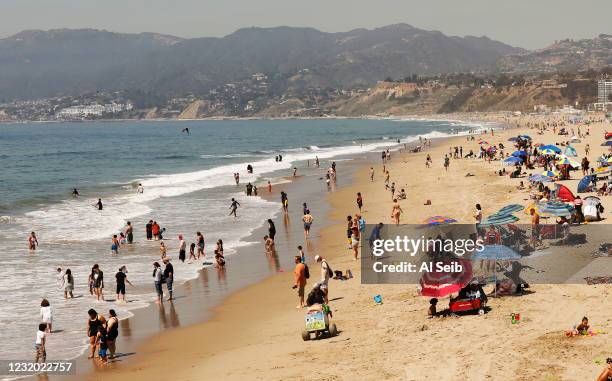 Number of people visit the beach next to the Santa Monica Pier as people talk about the differences regarding Spring break in Southern California...