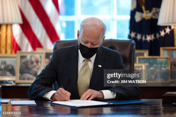 President Joe Biden signs the Paycheck Protection Program Extension Act of 2021 into law at the White House in Washington, DC, on March 30, 2021.