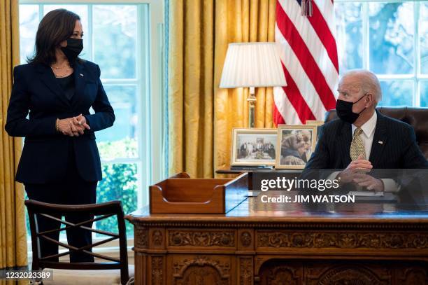 President Joe Biden speaks with US Vice President Kamala Harris after signing the Paycheck Protection Program Extension Act of 2021 into law at the...