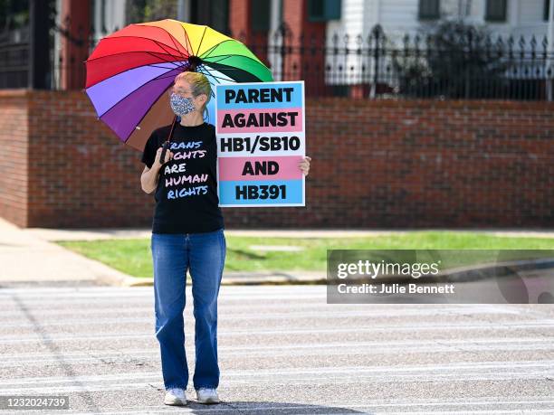 Jan Newton crosses the street to attend a rally held to draw attention to the anti-transgender legislation introduced in Alabama on March 30 at the...