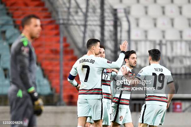 Portugal's forward Diogo Jota celebrates with teammates after scoring a goal during the FIFA World Cup Qatar 2022 qualification Group A football...