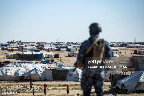 Special forces of the Syrian Democratic Forces keep watch on March 30, 2021 in the vicinity of al-Hol camp, the larger of two Kurdish-run...