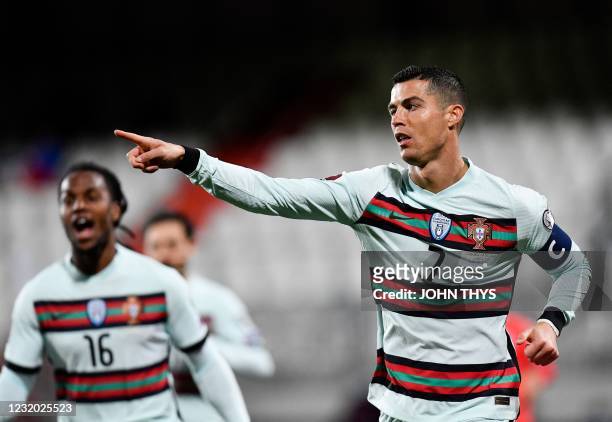 Portugal's forward Cristiano Ronaldo celebrates with teammates after scoring a goal during the FIFA World Cup Qatar 2022 qualification Group A...