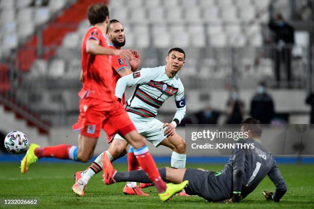 Luxembourg's goalkeeper Anthony Moris stops the ball shot by Portugal's forward Cristiano Ronaldo during the FIFA World Cup Qatar 2022 qualification...