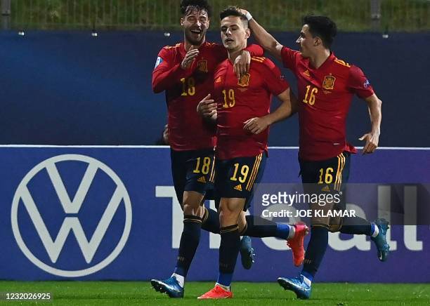 Spain's Dani Gomez is is congratulated by team mates Javier Puado and Manu Garcia during the 2021 UEFA European Under 21 Championship Group B...