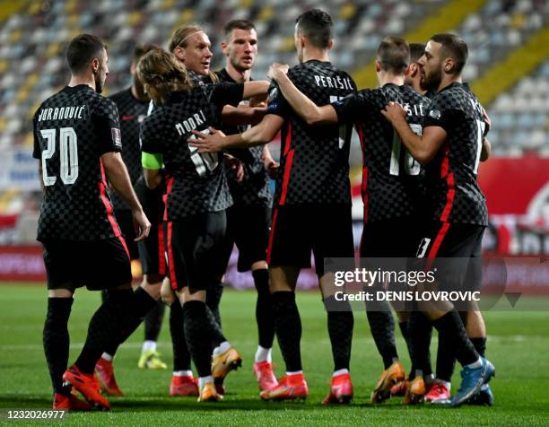 Croatia's forward Ivan Perisic is congratulated by team mates after scoring a goal during qualification football match for the FIFA World Cup Qatar...