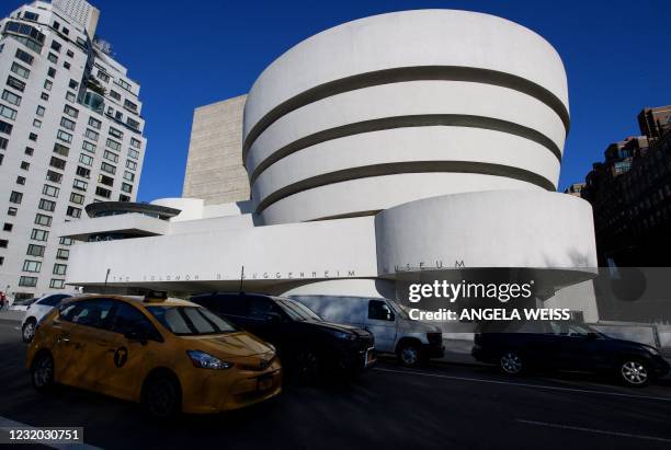 Yellow taxi cab drives past The Solomon R. Guggenheim Museum on March 30, 2021 in New York City.