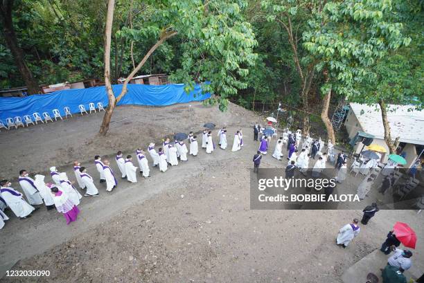 Roman Catholic priests arrive for the celebration of mass in Limasawa island, southern Leyte province in the central Philippines on March 31 to mark...