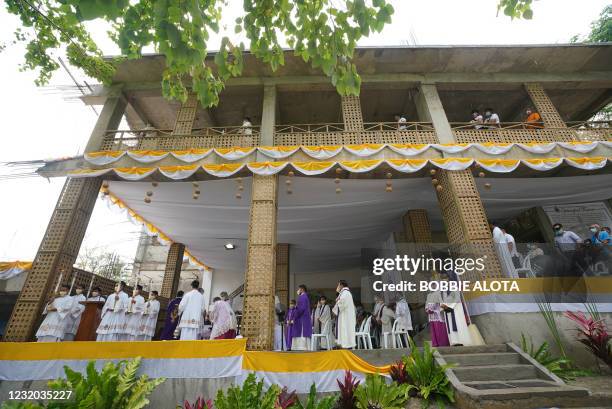Roman Catholic priests arrive for the celebration of mass in Limasawa island, southern Leyte province in the central Philippines on March 31 to mark...