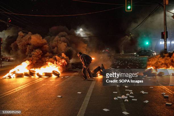 Protester seen burning tires in the middle of the street during the commemoration. Commemoration of the murder of the young brothers Rafael and...