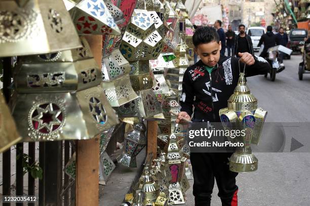 People walking at the Khayameya Street in old Cairo, Egypt, 30 March 2021.which is famous for selling Ramadan lanterns ahead of Islam's holy fasting...