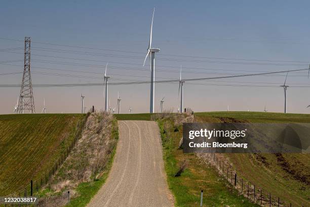 Wind turbines and power transmission lines at a wind farm near Highway 12 in Rio Vista, California, U.S., on Tuesday, March 30, 2021. President...