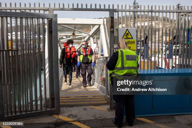 Asylum seekers arriving into Dover up the dock walkway ramp accompanied by Boarder Force officers after being on board a Boarder Force RIB boat, they...