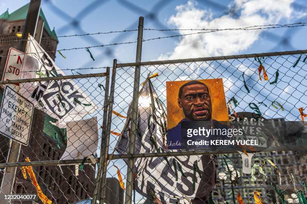 Poster with George Floyd's picture and a sign reads that "I Can't Breathe" hang from a security fence outside the Hennepin County Government Center...