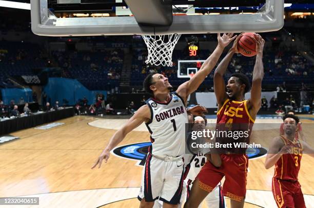 Evan Mobley of the USC Trojans tries to shoot over Jalen Suggs of the Gonzaga Bulldogs in the Elite Eight round of the 2021 NCAA Division I Men's...