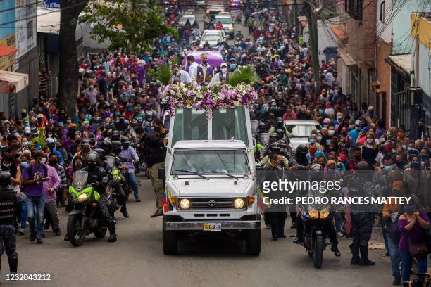 Catholic faithful wearing face masks against the spread of the novel coronavirus COVID-19 approach the popemobile carrying a figure of Jesus with the...