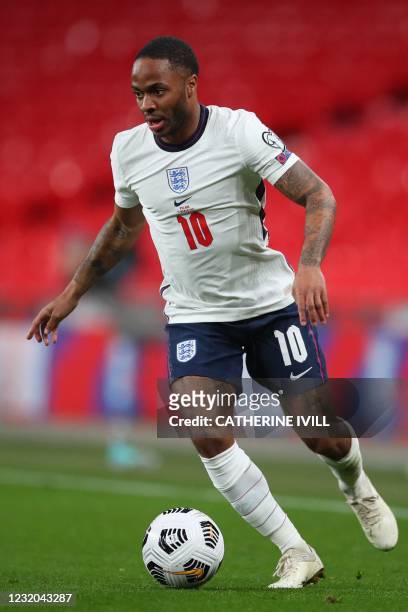 England's midfielder Raheem Sterling runs with the ball during the FIFA World Cup Qatar 2022 Group I qualification football match between England and...