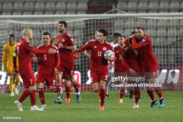 Georgia's players celebrate after scoring a goal during the FIFA World Cup Qatar 2022 qualification football match between Greece and Georgia at the...