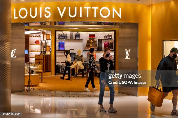 Shoppers seen at the French luxury fashion brand Louis Vuitton store in Hong Kong.