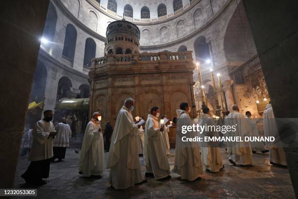 Fransiscan friars march in procession during a mass to commemorate the Washing of the Feet around the Edicule, traditionally believed to be the...