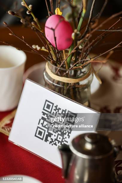 April 2021, Saxony, Augustusburg: QR codes for the menu are on the table in a restaurant. After five months of lockdown, hotels and restaurants here...