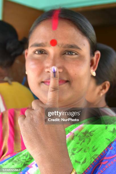 Voter display the indelible ink mark on their fingers after casting their votes during the second phase of elections for Assam state at Bamuni...