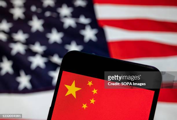 In this photo illustration the People's Republic of China flag is seen on an Android mobile device with United States of America , commonly known as...