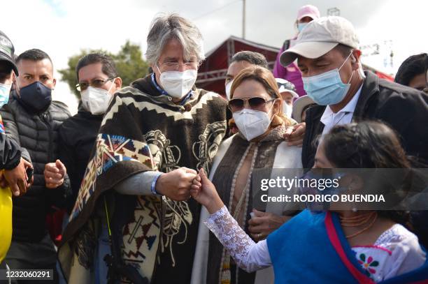 The Ecuadorean presidential candidate for the CREO movement, Guillermo Lasso, greets a girl with a fist bump upon arriving with his wife Maria de...