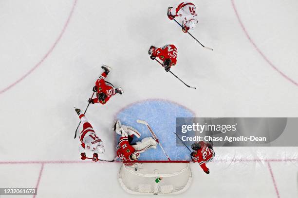 Shot by Warren Foegele of the Carolina Hurricanes enters the net past Kevin Lankinen of the Chicago Blackhawks for a goal in the second period at the...