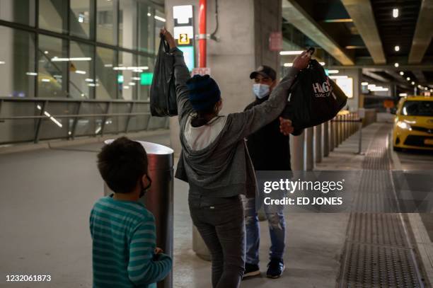 Reina , and her son Dariel from El Salvador are greeted by a cousin on March 30, 2021 after arriving at LaGuardia airport in New York, following...