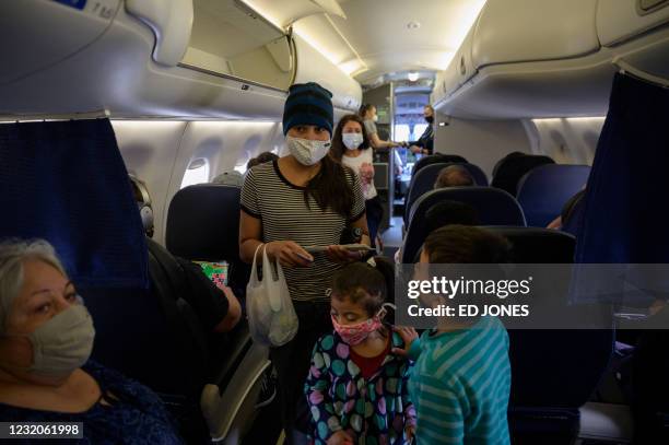 Reina , Diana and Dariel from El Salvador board a flight on March 30, 2021 from Houston to New York, following their release from a US government...