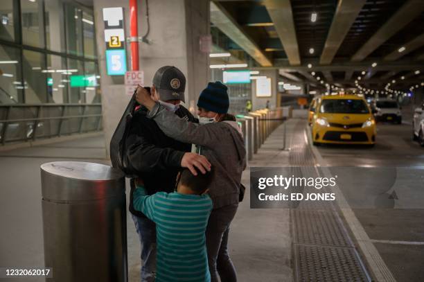 Reina , and her son Dariel from El Salvador are greeted by a cousin on March 30, 2021 after arriving at LaGuardia airport in New York following their...