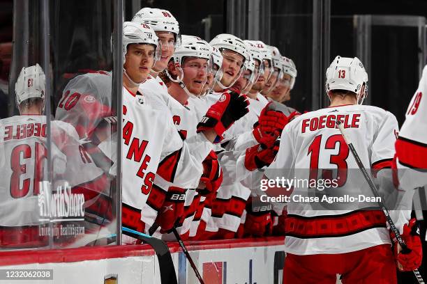 Warren Foegele of the Carolina Hurricanes celebrates with teammates after scoring a goal in the second period against the Chicago Blackhawks at the...