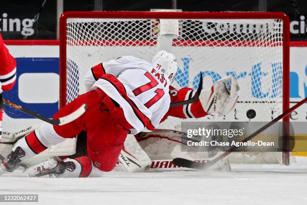 Jesper Fast of the Carolina Hurricanes scores a goal past Kevin Lankinen of the Chicago Blackhawks in the third period at the United Center on April...