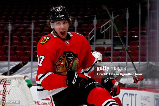 Dylan Strome of the Chicago Blackhawks celebrates after scoring a goal in the third period against the Carolina Hurricanes at the United Center on...