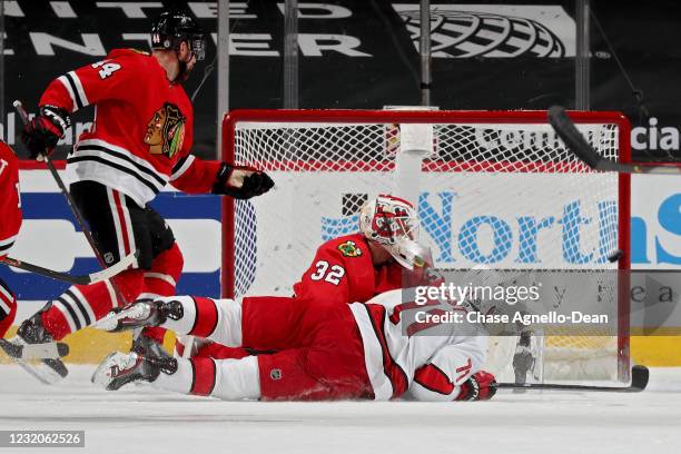 Jesper Fast of the Carolina Hurricanes scores a goal past Kevin Lankinen of the Chicago Blackhawks in the third period at the United Center on April...